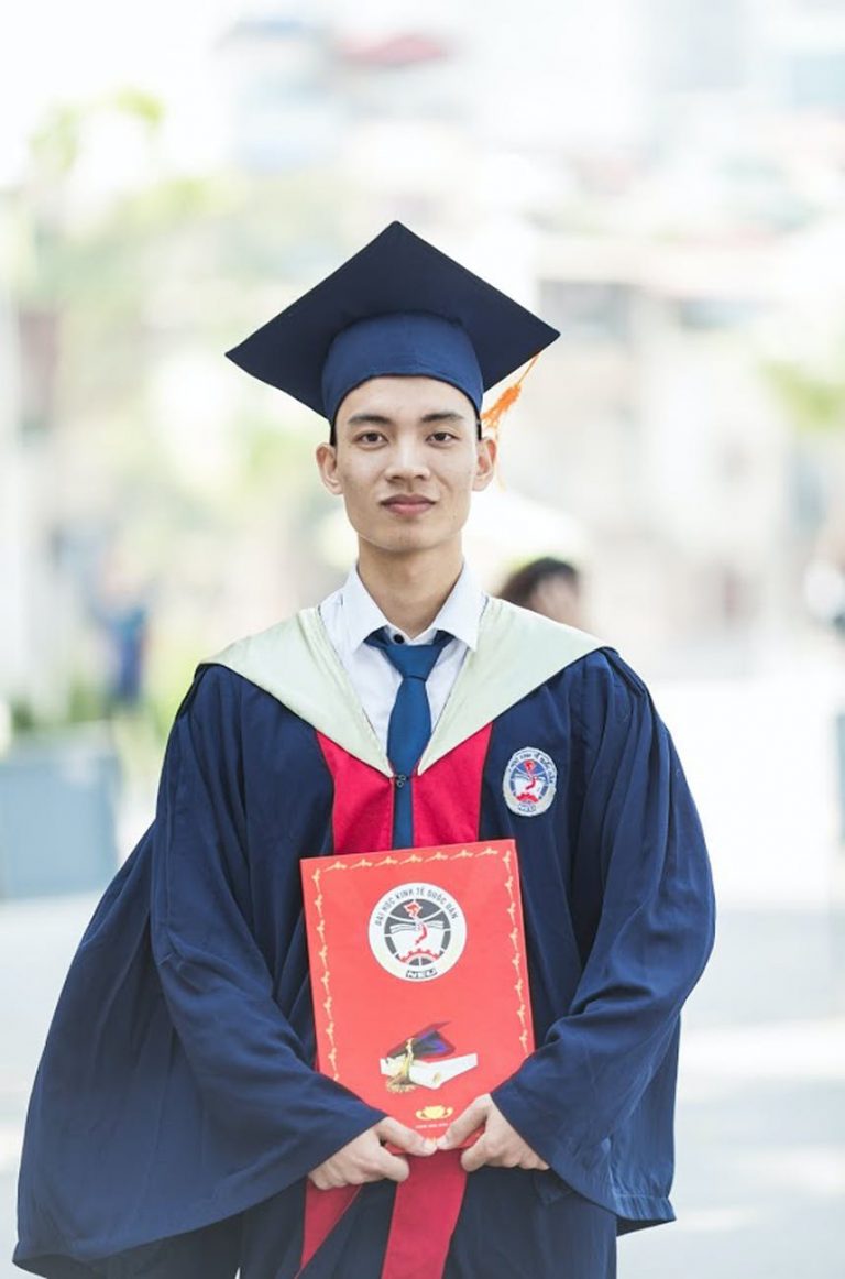 man in toga holding diploma