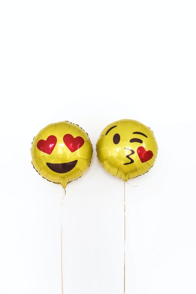 pair of yellow foil balloons with smiley face