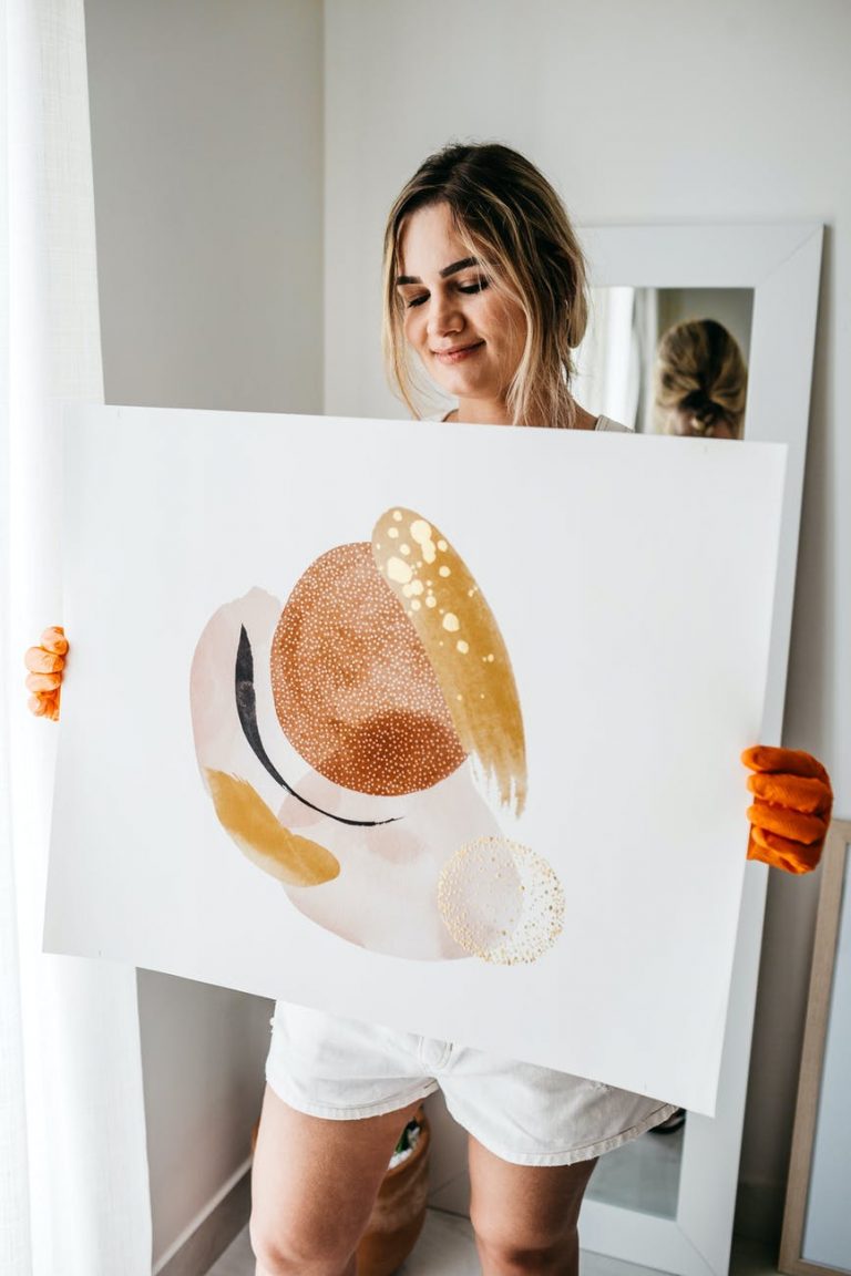 happy woman carrying abstract picture