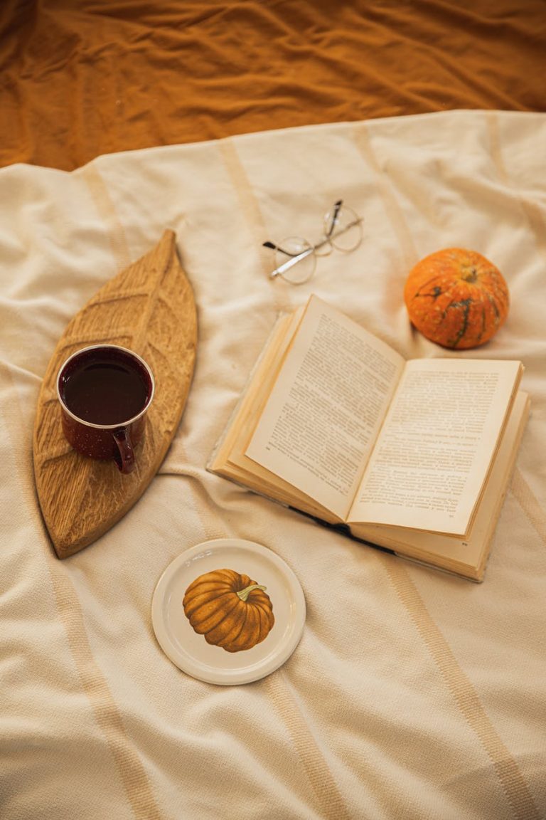 book and cup of coffee on the bed