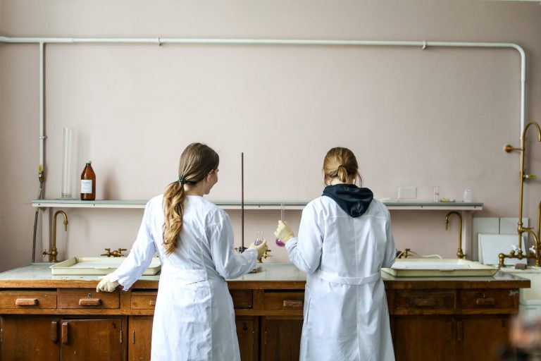 women in white laboratory gown standing