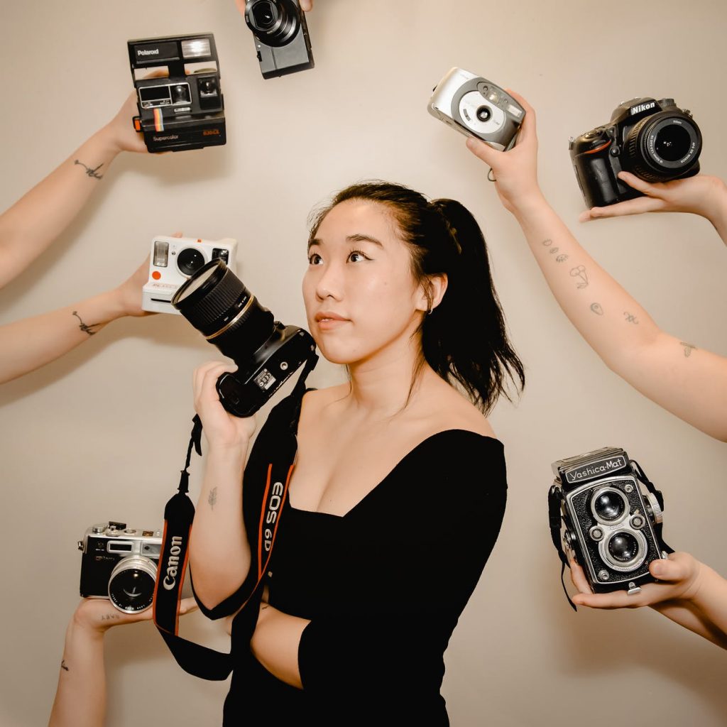 asian woman with photo camera in hand