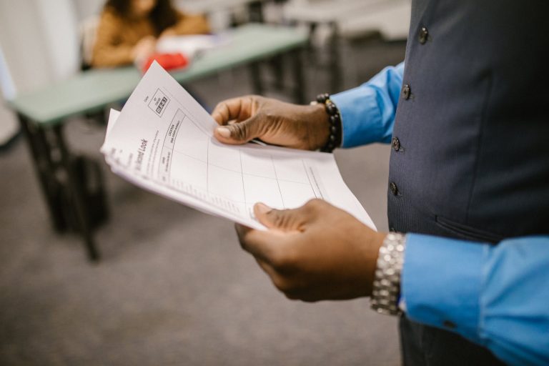 person in blue long sleeve shirt holding test paper