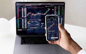 Phone and laptop displaying stocks