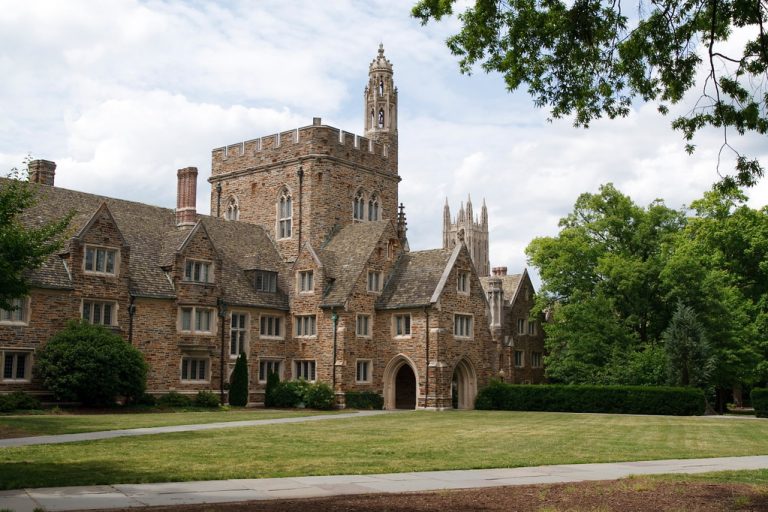 Image of Duke University building with a lawn