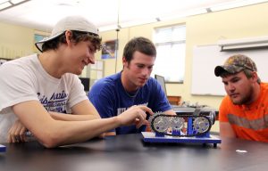 Three students working on an engineering project
