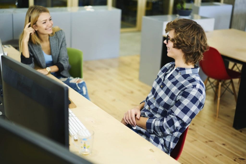 College Essay Coach 2 - students talking in computer lab about essay writing