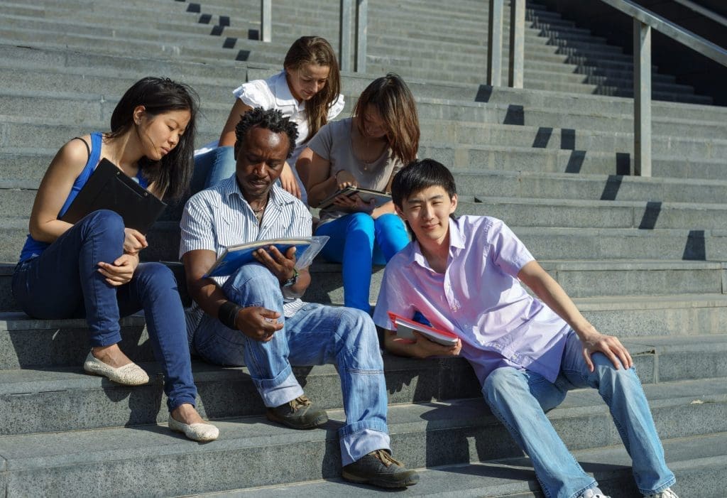 students sitting on staircase