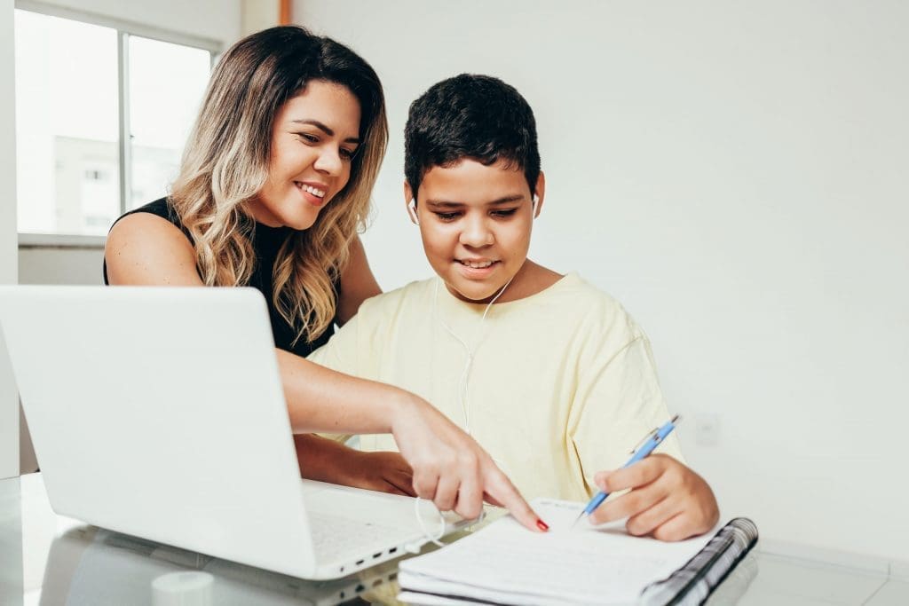young student working at home with parent