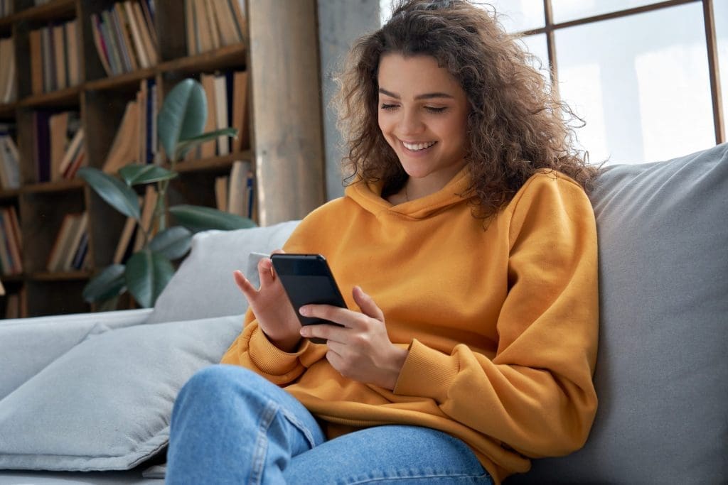 student on phone at home