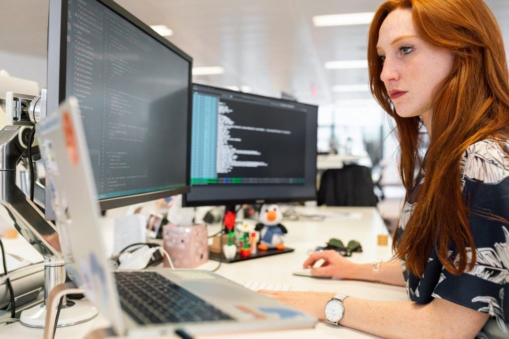 Young woman coding on computer