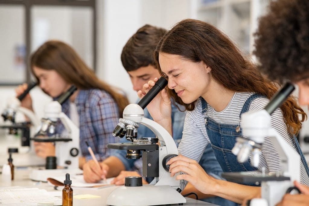 student looking in microscope