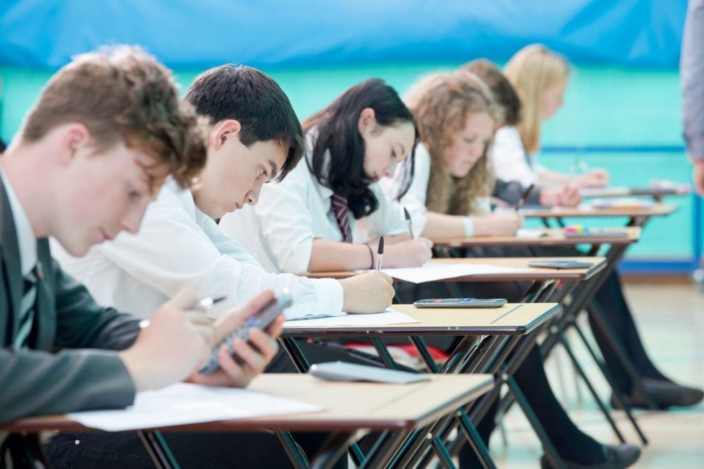 Focused students taking exam in middle school.