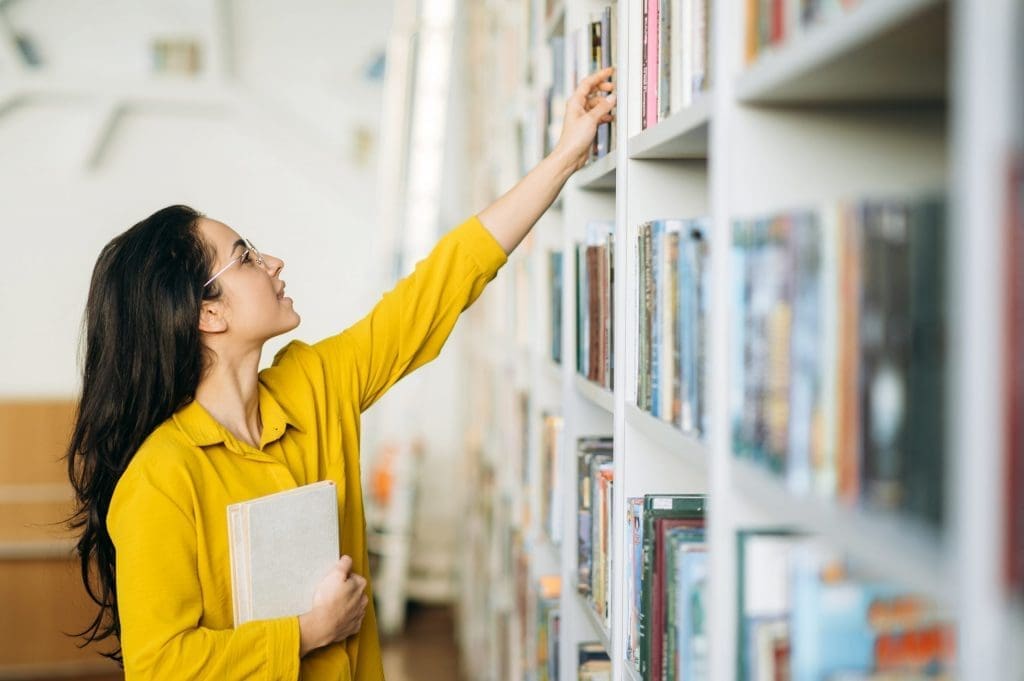 student picking books