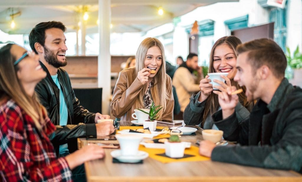 students chatting in coffee shop