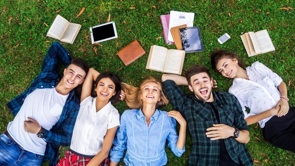 students laying on the grass