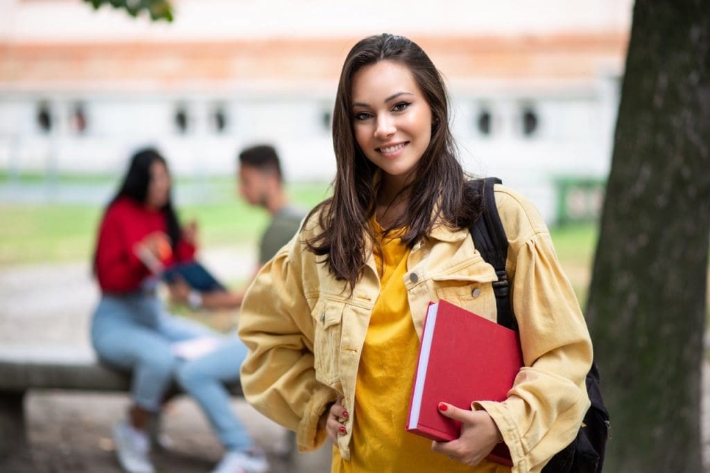 student holding book