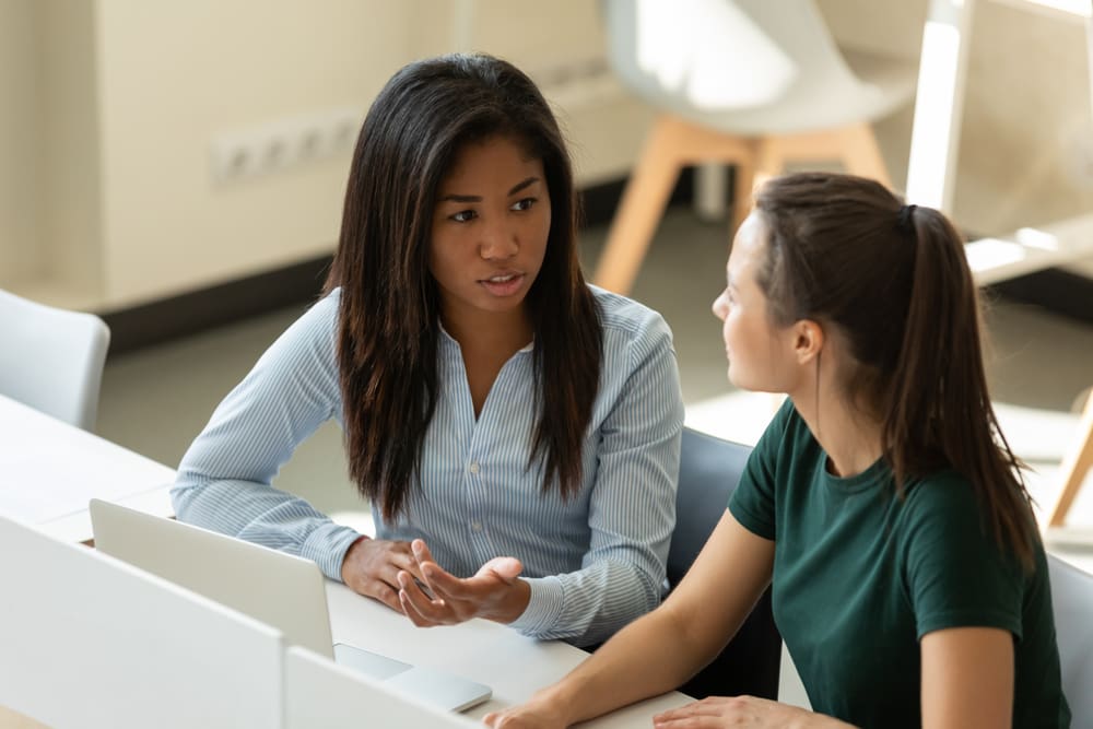 interns discussing training task in a workspace