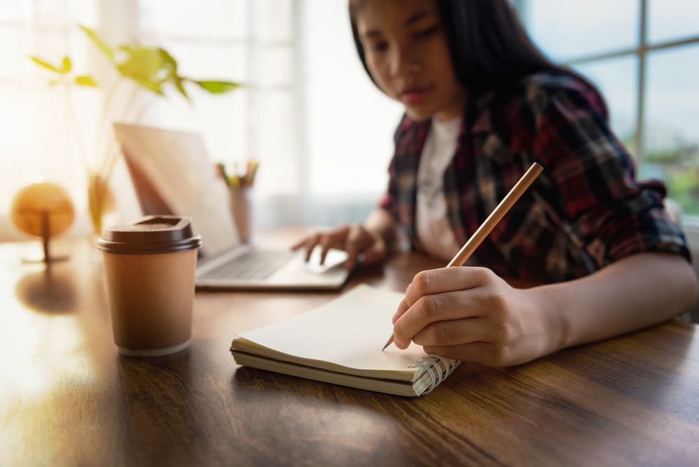 students taking notes on desk