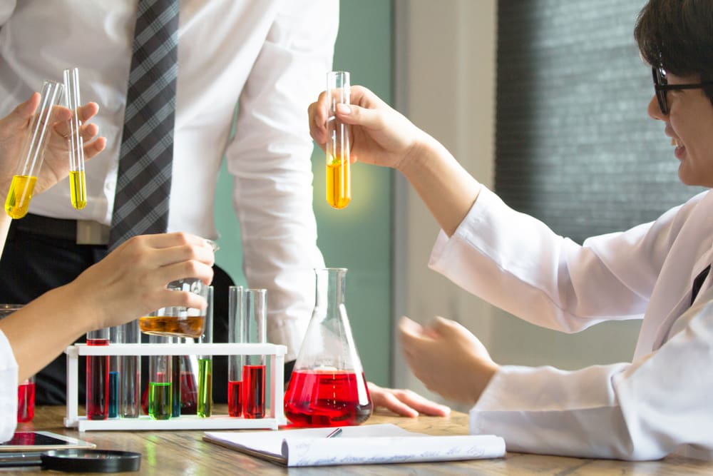 medical students with liquid test tubes