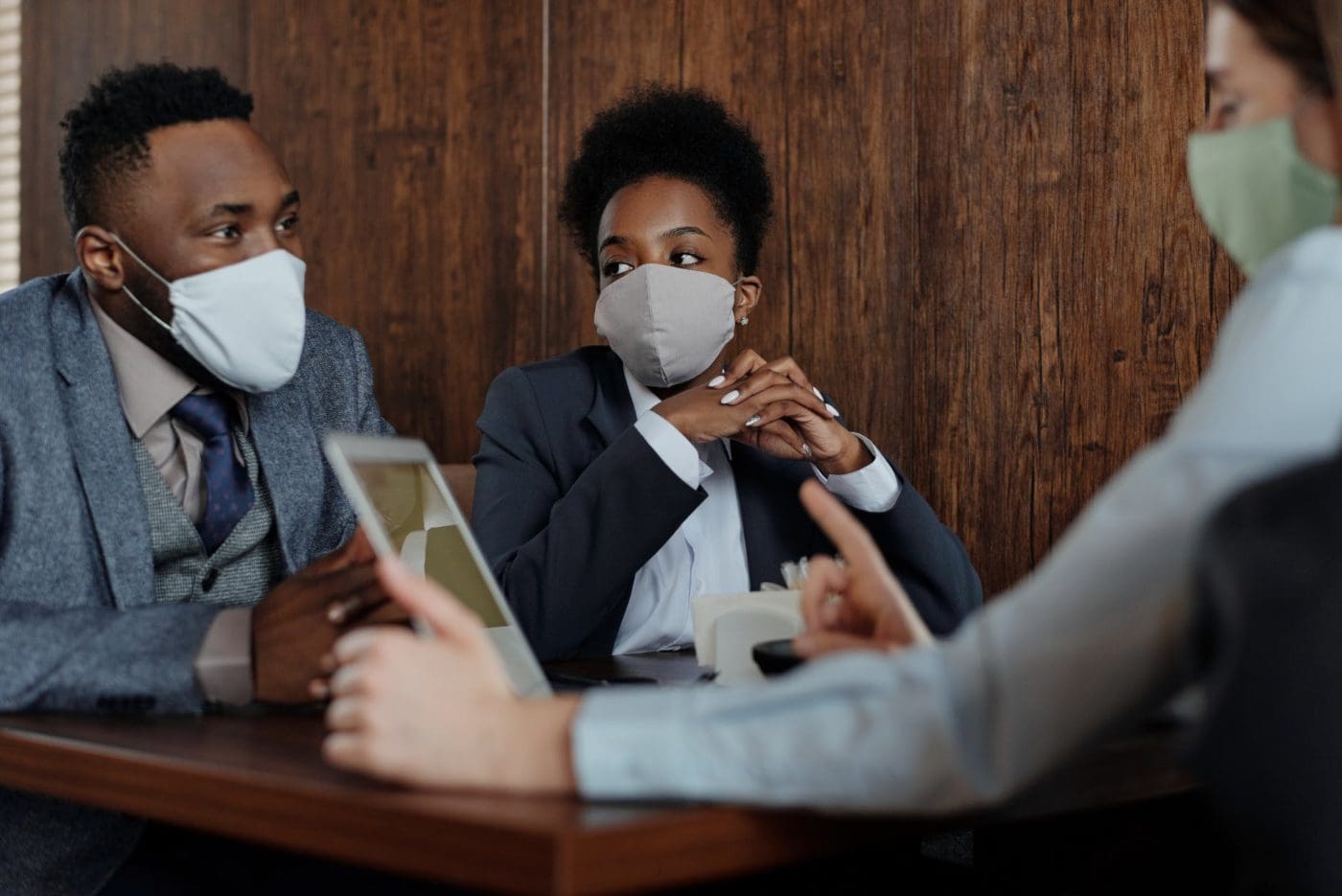 business people wearing face masks and talking