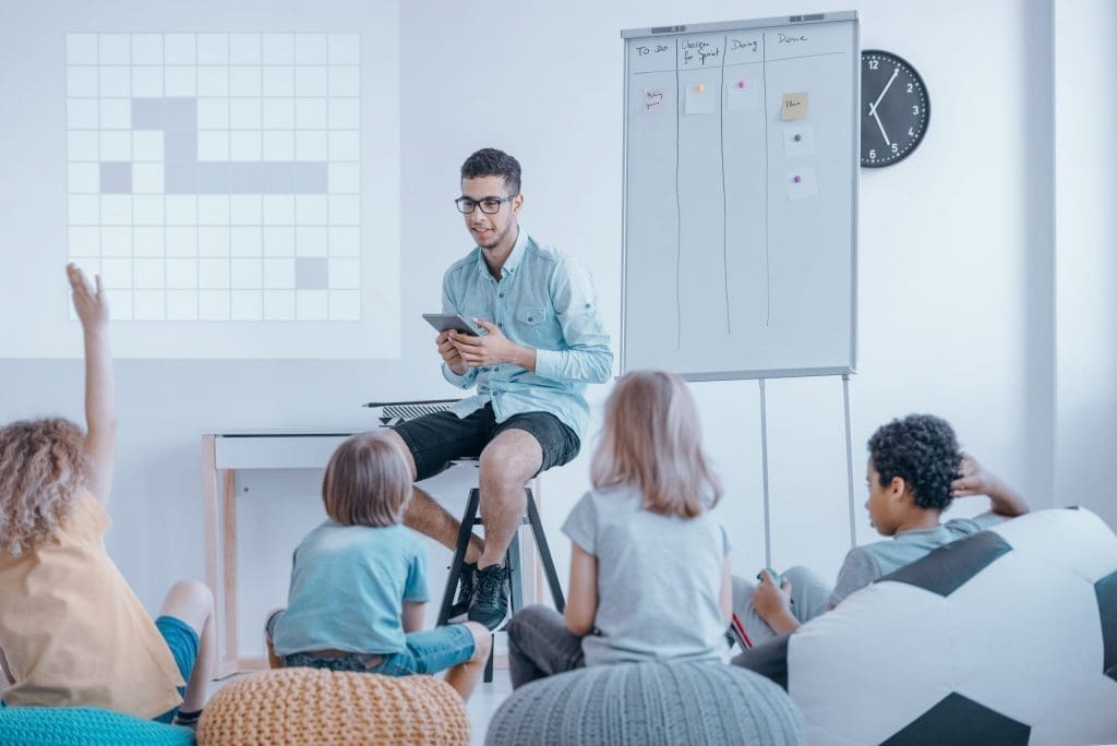 Student volunteering to tutor a classroom of children