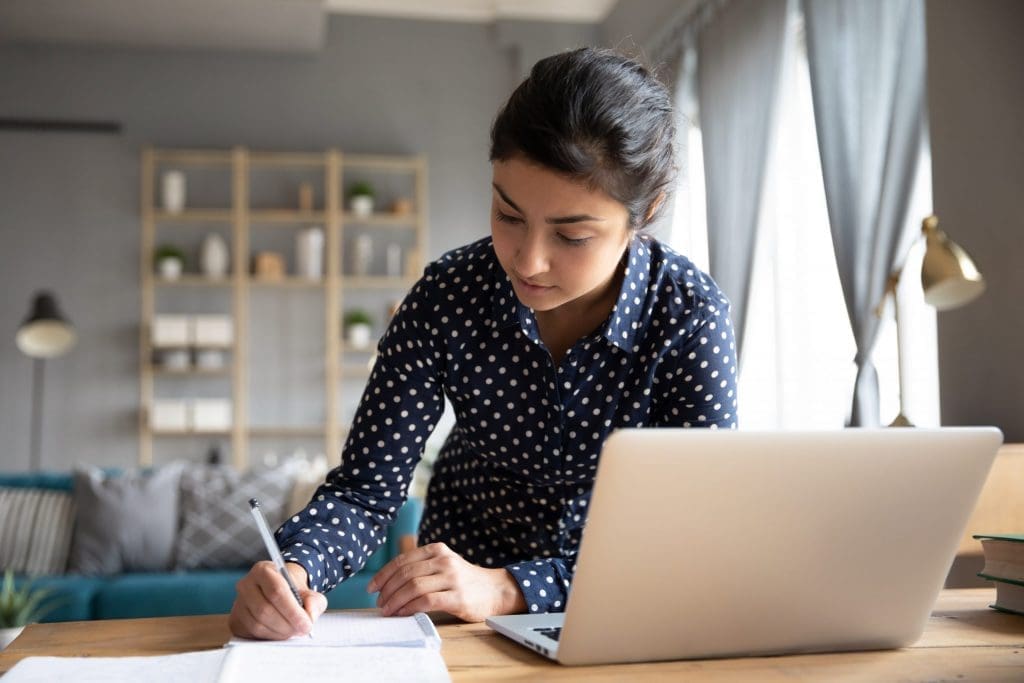 student taking notes at home