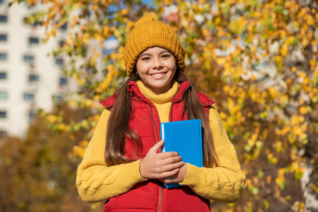Happy high school student in fall semester preparing for college admissions