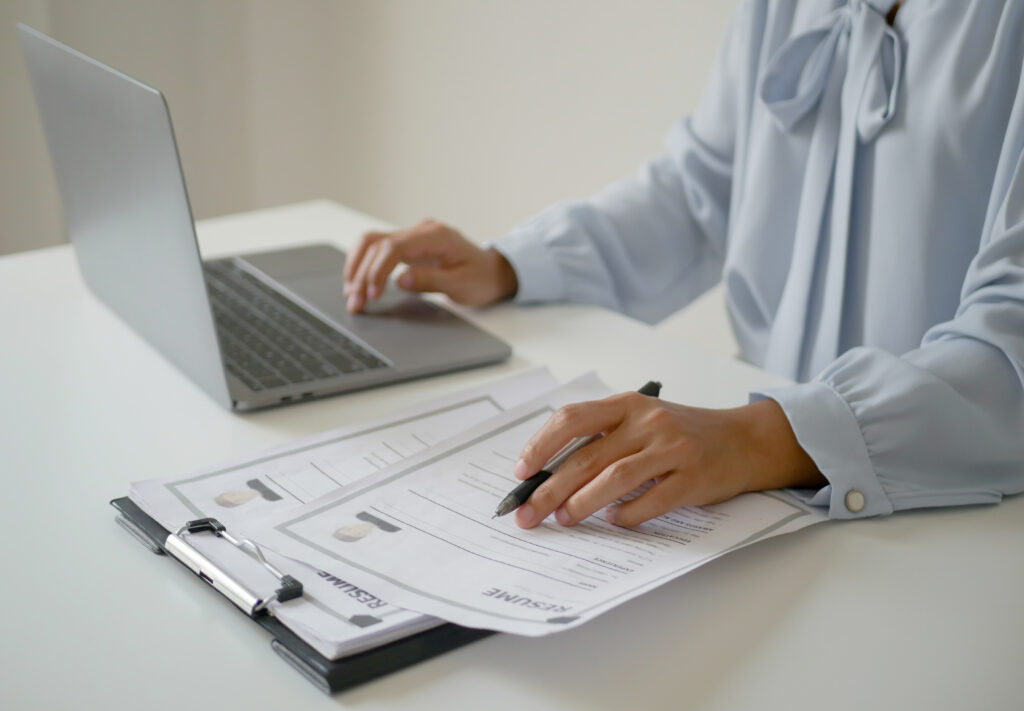 College admissions reviewer looking at resumes and letters of recommendation