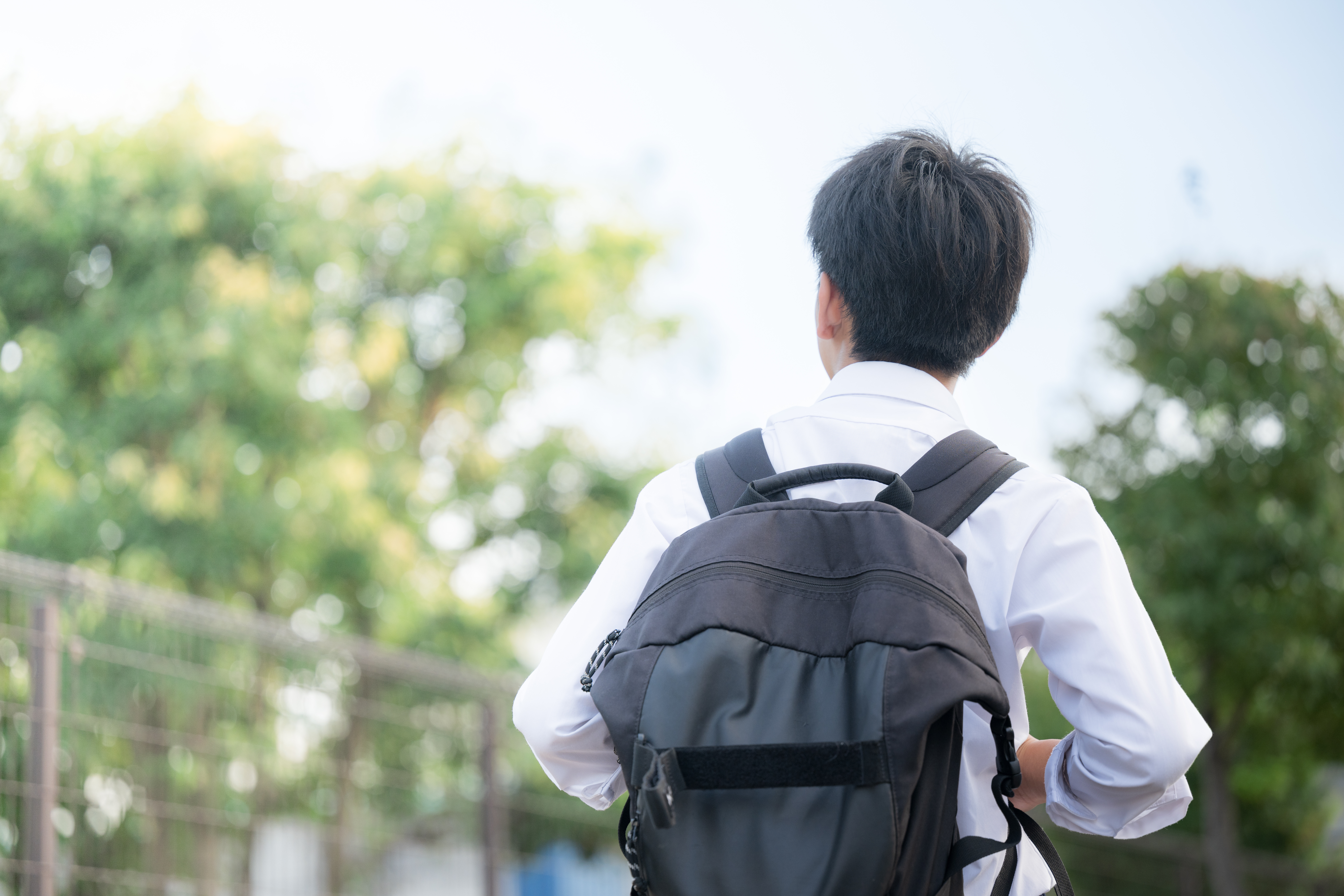 High school student with backpack walking