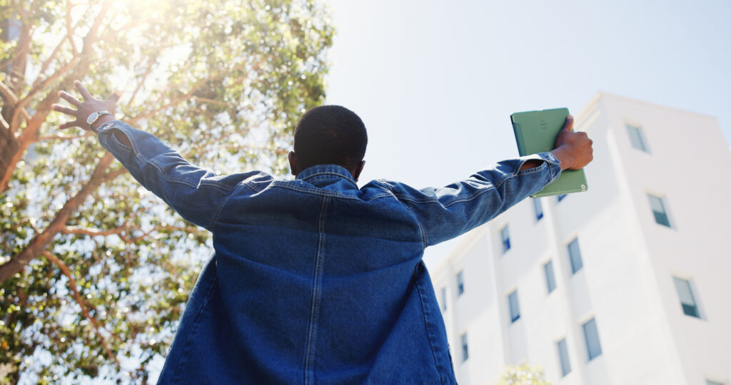 Man, student and tablet in city with freedom, academic achievement or scholarship opportunity. Back, low angle or person outdoor with tech for university acceptance, success or funding grant to study.