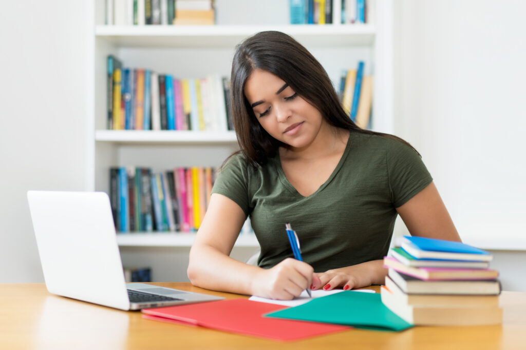 High school student working on a college essay final review before submission.
