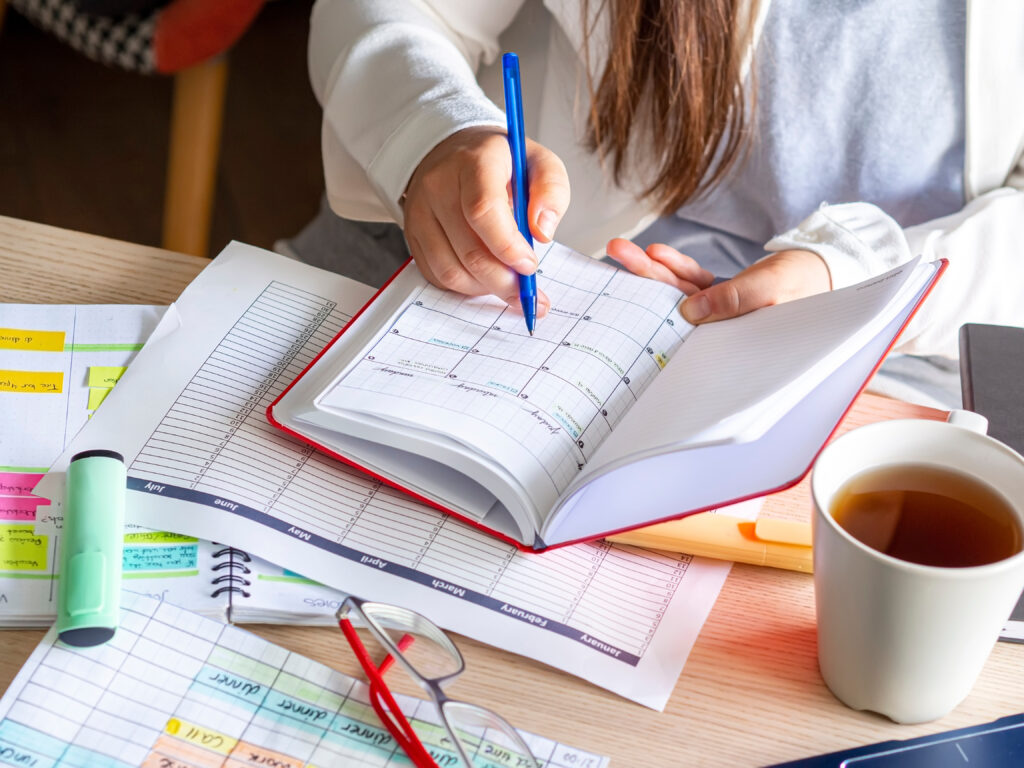 Student working on a planner for college admissions in high school.
