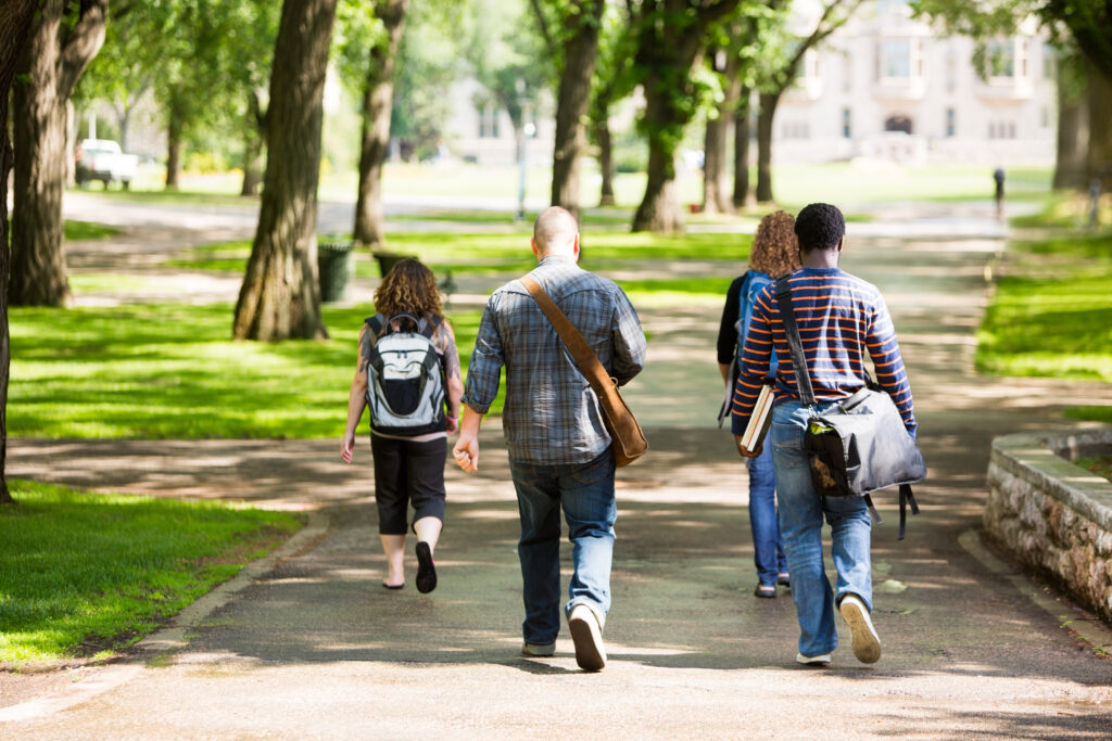 Students touring a college campus make decisions about their final college list after visiting.
